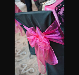 Fuschia Table Runner with Black Flock Runner on Black Table Linen with Fuschia Organza Sash on Black Chair Covers at Rockliffe Hall