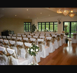 Bronze and Ivory Double Organza Bows on White Chair Covers at Heather Glen