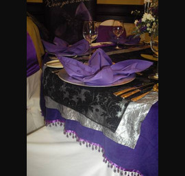 Cadbury's Purple Velvet Runner topped with Silver Pintuck Runner and a Black Damask Runner at The Hallmark Hotel