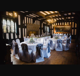 Silver Satin Bows on White Chair Covers in The Banqueting Room