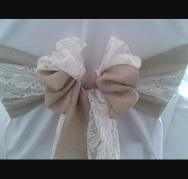 Burlap and lace chair sash tied in a bow on white chair covers