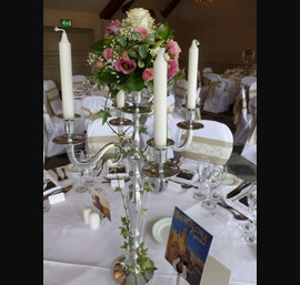 Vintage floral arrangement at Coed Y Mwstwr with burlap and lace chair sashes